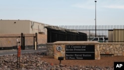 A guarded gate opens at Border Patrol Station One, Oct. 28, 2019, in El Paso, Texas. Immigration lawyers say some migrants are held as part of a pilot program that aims to deport asylum seekers within 10 days.