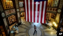 A large flag hangs from the ceiling as people vote at the San Francisco Columbarium & Funeral Home in San Francisco, Nov. 5, 2024.