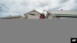 Rakisha Murray cries as she arrives to see her mother's home, after she returned from evacuation with her mother and other family in Lake Charles, La., in the aftermath of Hurricane Laura, Aug. 30, 2020.