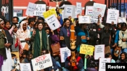 Demonstrators shout slogans as they hold placards during a protest outside a church in New Delhi, India, Feb. 5, 2015. 