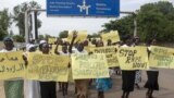 FILE - Women march carrying placards with messages demanding peace and their rights, on the streets of South Sudan's capital, Juba, July 13, 2018.