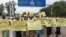 FILE - Women march carrying placards with messages demanding peace and their rights, on the streets of South Sudan's capital, Juba, July 13, 2018.