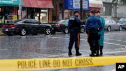 Police officers stand guard while law enforcement officers search an address during an investigation into Ahmad Khan Rahami, who was wanted for questioning in an explosion in New York, which authorities believe is linked to the explosive devices found in New Jersey, Sept. 19, 2016.