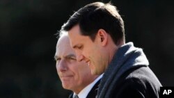 FILE - White House staff secretary Rob Porter, right, walks with White House Chief of Staff John Kelly to board Marine One on the South Lawn as they leave the White House in Washington, Feb. 2, 2018.