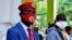 FILE - Ugandan musician turned politician, Robert Kyagulanyi, left, also known as Bobi Wine, and Uganda's four-time Presidential candidate Kizza Besigye attend a joint news conference in Kampala.