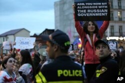 FILE — Demonstrators denounce the "Russian Law" and make their protest heard internationally in the center of Tbilisi, Georgia, on May 3, 2024.