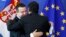 European Commision President Jose Manuel Barroso greets Serbian Prime Minister Ivica Dacic (L) after a joint news conference at the EU Commission headquarters in Brussels, June 26, 2013. 