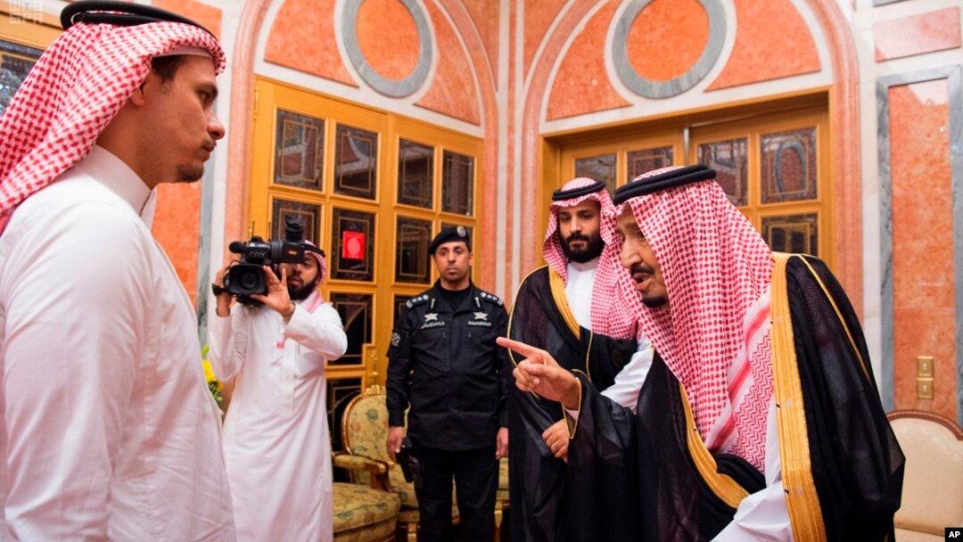 In this photo released by Saudi Press Agency, SPA, Saudi King Salman, right, points to Salah, a son, of Jamal Khashoggi as Crown Prince Mohammed bin Salman, second right, looks on, in Riyadh, Saudi Arabia, Oct. 23, 2018. 
