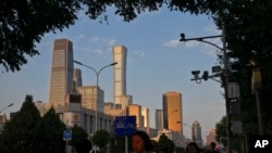 资料图片：2023年8月14日，在北京的高峰时间，人们走在中央商务区附近。（美联社）