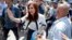FILE - Argentina's former President Cristina Fernandez greets supporters outside a courthouse in Buenos Aires, Argentina, Oct. 26, 2017. 