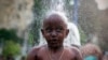 A Hindu devotee gets showered as part of a cleaning ritual before his pilgrimage during the Thaipusam festival in Kuala Lumpur, Malaysia.