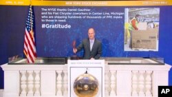 NYSE security chief Kevin Fitzgibbons rings the closing bell, April 15, 2020, in New York, to thank Fiat Chrysler workers who are shipping masks to those in need. The NYSE is saluting COVID responses via its #Gratitude campaign.