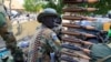 FILE - A South Sudanese soldier stands next to a machine gun mounted on a truck in Malakal town, northeast of Juba, South Sudan.