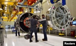 FILE - Technicians build engines for jetliners at a General Electric (GE) factory in Lafayette, Indiana, March 29, 2017.