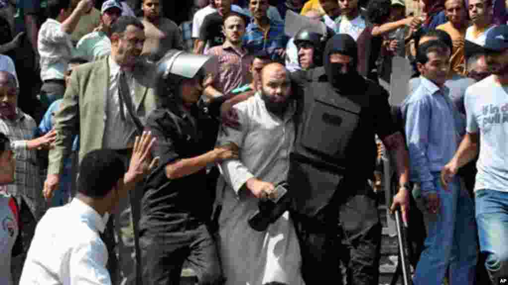 An Egyptian woman with blood on her clothes screams during clashes between security forces and supporters of Egypt's ousted President Morsi, Aug. 16, 2013.