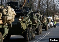 FILE - A convoy of U.S. troops, a part of NATO's reinforcement of its eastern flank, drive from Germany to Orzysz in northeast Poland, March 28, 2017.