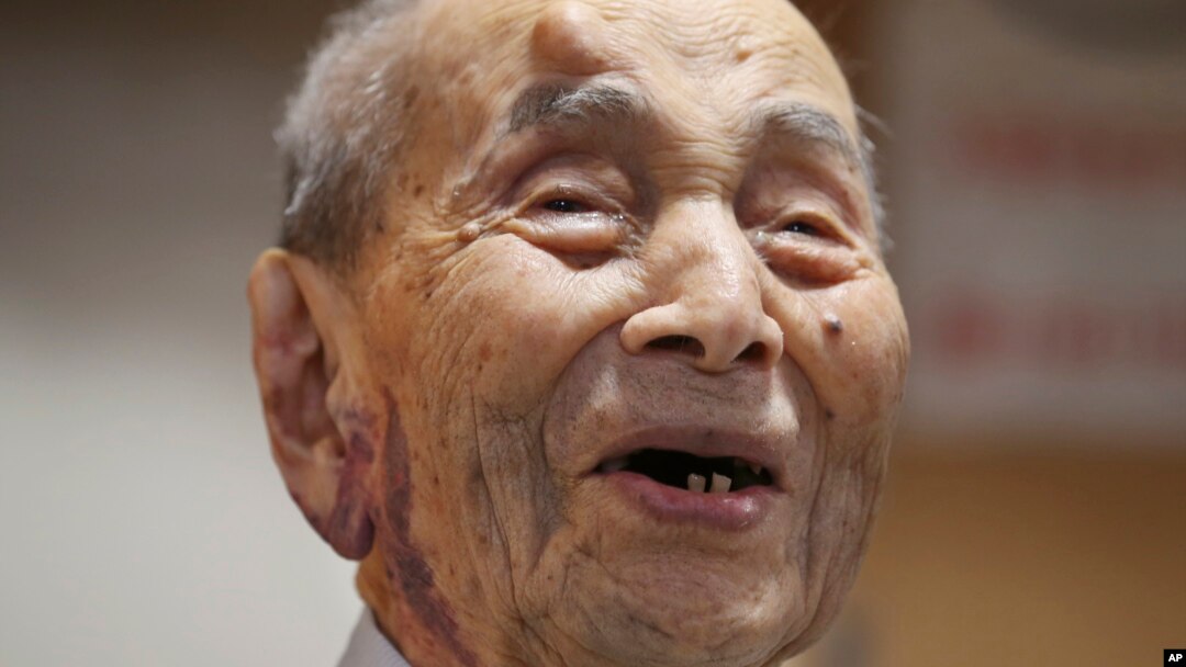 Yasutaro Koide, the 112-year-old living in the central Japanese city of Nagoya, smiles upon being formally recognized as the world's oldest man by the Guinness World Records at a nursing home in Nagoya, Aug. 21, 2015.