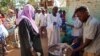 Volunteers distribute food to residents and displaced people in Omdurman