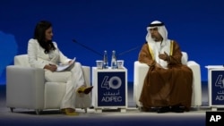 Moderator Hadley Gamble, left, looks on as UAE Minister of Energy and Infrastructure Suhail al-Mazrouei speaks in a panel during the Abu Dhabi International Petroleum Exhibition and Conference in Abu Dhabi, United Arab Emirates, Nov. 4, 2024.