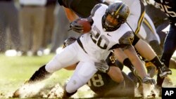 FILE - West Virginia running back Shawne Alston plays in the NCAA football game between Pittsburgh and West Virginia, Nov. 26, 2010, in Pittsburgh. Alston and others sued and the NCAA over additional payments to athletes. (AP Photo/Keith Srakocic)