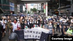 香港民主派前立法會議員朱凱迪（手持橫額者左起）、民陣召集人陳皓桓、社民連前立法會議員梁國雄、民主黨前主席及前立法會議員胡志偉等8名民主派人士，因今年7-1遊行，12月8日被警方拘捕。（陳皓桓Facebook 圖片）