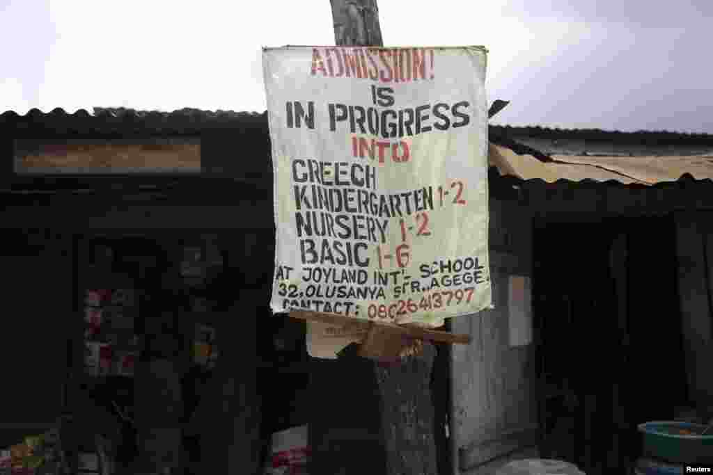A banner advertising a school is seen on an electricity pole in front of a shop at a foodstuff market in the Agege district of Lagos.