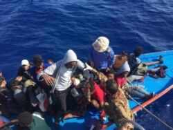 Migrants in a dinghy are rescued by the Libyan coast guard in the Mediterranean Sea off the coast of Libya, Oct. 18, 2019.