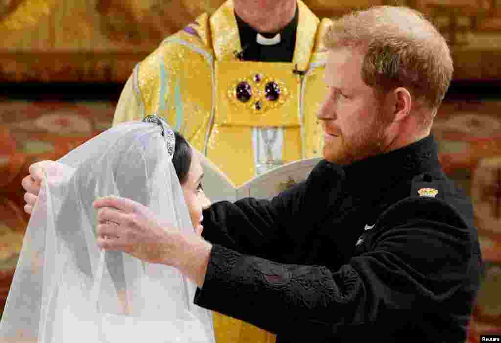 Prince Harry and Meghan Markle in St George's Chapel at Windsor Castle during their wedding service, conducted by the Archbishop of Canterbury Justin Welby in Windsor, Britain, May 19, 2018. 