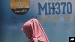 Seorang gadis berdiri di depan papan pesan belasungkawa selama acara Hari Mengenang MH370 di Kuala Lumpur, Malaysia, pada 3 Maret 2019. (Foto: AP)