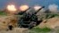 FILE - US-made CM-11 tanks (in background) are fired in front of two 8-inch self-propelled artillery guns during the 35th 'Han Kuang' (Han Glory) military drill in southern Taiwan's Pingtung county on May 30, 2019. 