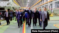 U.S. Secretary of State John Kerry walks through the Locomotive Plant during a tour in Astana, Kazakhstan on Nov. 2, 2015. 