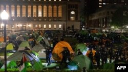 TOPSHOT - NYPD officers in riot gear enter Columbia University's encampment as they evict a building that had been barricaded by pro-Palestinian student protesters in New York City on April 30, 2024.