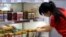 A store worker adjusts Australian products on display for sale in Sydney, Australia, Jan. 27, 2016.