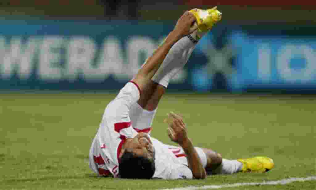 North Korea's Jong Il Gwan stretches his leg after having a cramp during a U-20 World Cup group F soccer match against Mexico in Medellin, Colombia, Monday, Aug. 1, 2011. (AP Photo/Ricardo Mazalan)