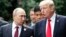 U.S. President Donald Trump and Russia's President Vladimir Putin talk during a photo session at the APEC Summit in Danang, Vietnam, Nov. 11, 2017. 
