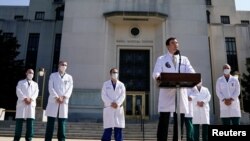 U.S. Navy Commander Dr. Sean Conley, the White House physician, is flanked by other doctors as he speaks to the media about U.S. President Donald Trump's health, at Walter Reed National Military Medical Center in Bethesda, Maryland, Oct. 4, 2020.