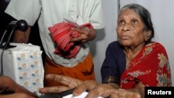 FILE - A villager goes through the process of a fingerprint scanner during Unique Identification (UID) database system in the Pathancheru village, in Medak district of the southern Indian state of Andhra Pradesh April 27, 2010.