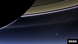 In this rare image taken on July 19, 2013, the wide-angle camera on NASA's Cassini spacecraft has captured Saturn's rings and our planet Earth and its moon in the same frame. (NASA/JPL-Caltech/Space Science Institute)