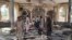 Warga memeriksa kerusakan di dalam masjid di Kunduz, Afghanistan, setelah serangan bom berlangsung saat sholat Jumat (8/10).
