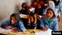 FILE - Afghan girls attend a class at the Aschiana center in Kabul, Afghanistan March 5, 2019. 