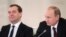 Russian President Vladimir Putin (R) and Prime Minister Dmitry Medvedev take part in a meeting on social and economic development in Moscow's Kremlin, Dec. 23, 2013.