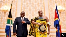 FILE - South Africa's President Cyril Ramaphosa, poses with eSwatini's King Mswati III after a meeting focused on political and security developments in the kingdom, November 3, 2021