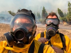 Associated Press photographer Marcio Jose Sanchez, left, takes a selfie with fellow AP photographer Gregory Bull while covering the Easy Fire on Oct. 30, 2019, in Simi Valley, California.