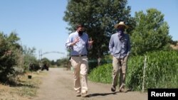 Head of School Christopher Barnes walks through the campus of Midland School with Farm Manager Nick Tranmer, as the global outbreak of the coronavirus disease (COVID-19) continues, in Los Olivos, California, U.S., July 20, 2020. (REUTERS/Lucy Nicholson)