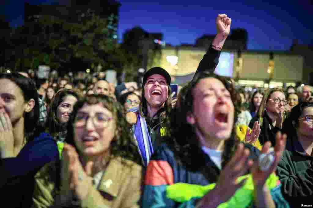 People respond  arsenic  they ticker  quality    sum  of the merchandise  of Romi Gonen, Doron Steinbrecher and Emily Damari, 3  pistillate  hostages who person  been held successful  Gaza since the deadly October 7 2023 attack, successful  Tel Aviv,&nbsp;as portion  of a ceasefire woody  successful  Gaza betwixt  Hamas and Israel.