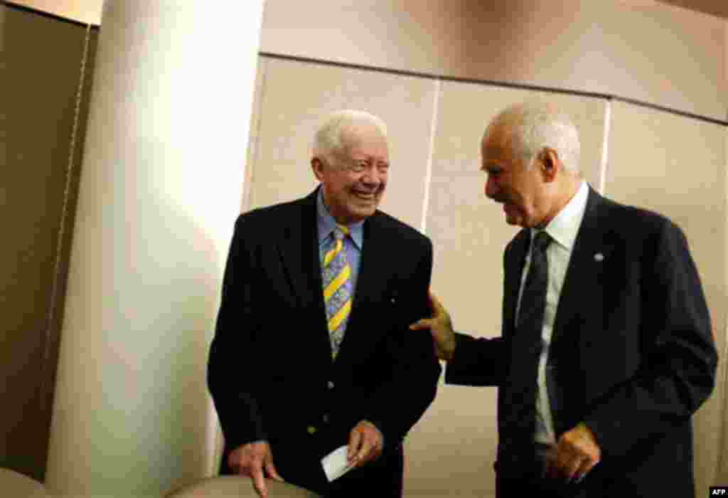 Former President Jimmy Carter, left, and OPEC Fund for International Development Director General Suleiman Jasir Al-Herbish, speak before signing an agreement for two $500,000 grants to fund the Carter Center's programs to eliminate Guinea worm and river 