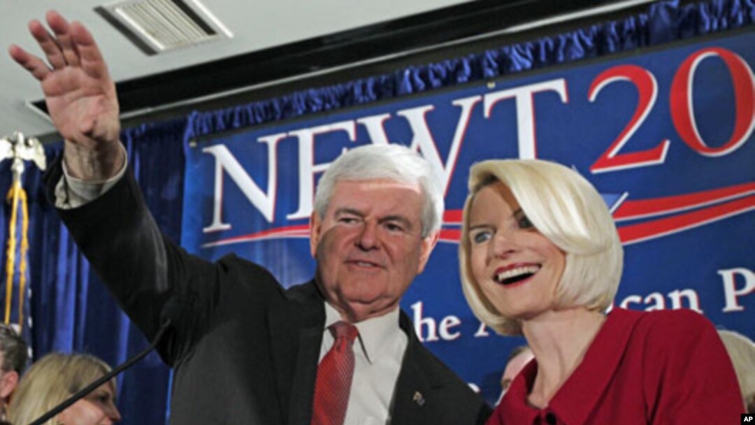 Republican presidential candidate and former House Speaker Newt Gingrich waves to the crowd with his wife Callista during a South Carolina Republican presidential primary night rally, Jan. 21, 2012, in Columbia, S.C.