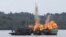 FILE - Malaysian and Vietnamese fishing boats are destroyed for illegal fishing by the Ministry of Maritime Affairs and Fisheries, police and navy, in Batam, Riau Islands, Indonesia, April 5, 2016. The Indonesian government reportedly sank 28 illegal foreign fishing boats simultaneously in nine locations across the country. 