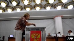 A woman casts her ballot on the first day of local elections in Russia, at a polling station in Rostov-on-Don on September 8, 2023.