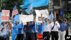 FILE - Uighur supporters march towards the Chinese Embassy after a Uighur protest rally at Dupont Circle in Washington, July 7, 2009. Sunday's violence in China's Xinjiang region between Muslim Uighurs and ethnic Han Chinese has killed at least 156.